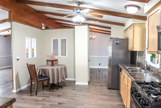 a kitchen with stainless steel appliances granite countertop a stove and a dining table