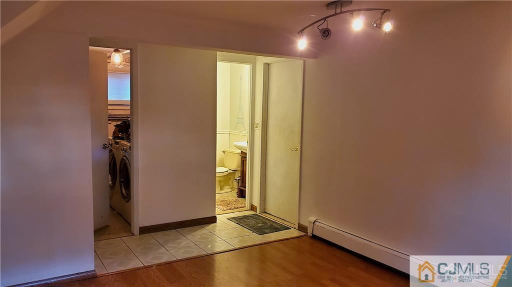 29 Finley Road Edison, NJ 08817 - Photo 8 of 18 an empty room with wooden floor and windows
