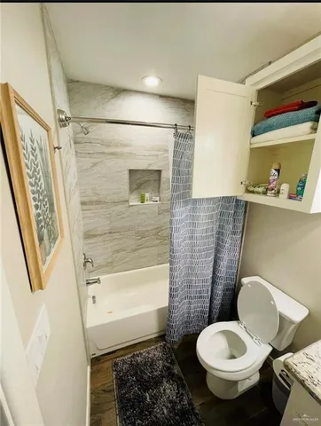 a bathroom with a toilet and a shower