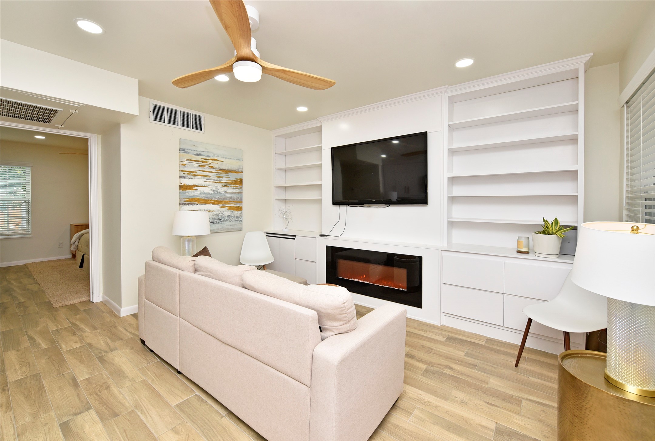 3224 Timmons Lane, Unit 112 Houston, TX 77027 - Photo 17 of 30 a living room with furniture a fireplace and a flat screen tv