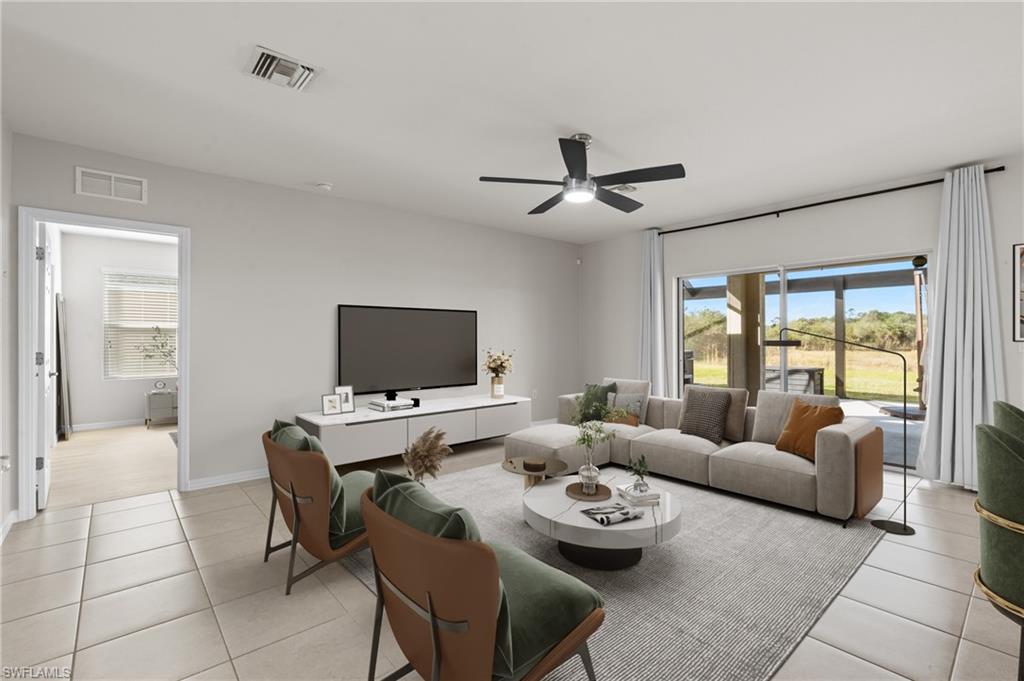 8149 Gopher Tortoise Trail Lehigh Acres, FL 33972 - Photo 17 of 50 a living room with furniture and a flat screen tv