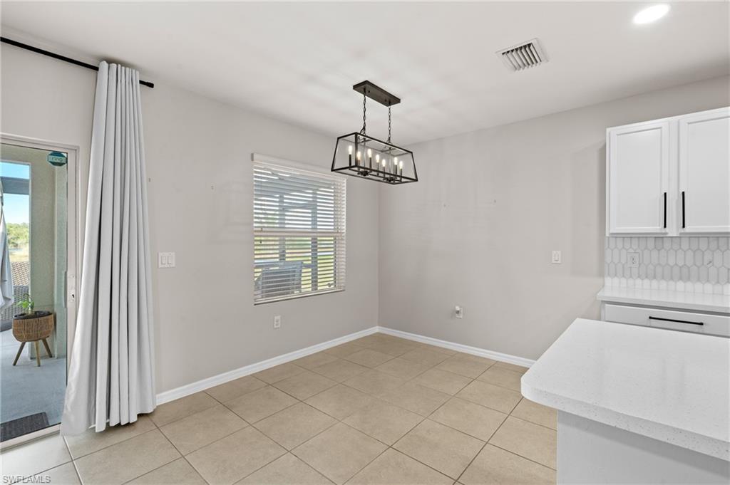 8149 Gopher Tortoise Trail Lehigh Acres, FL 33972 - Photo 24 of 50 a very nice looking room with a chandelier fan