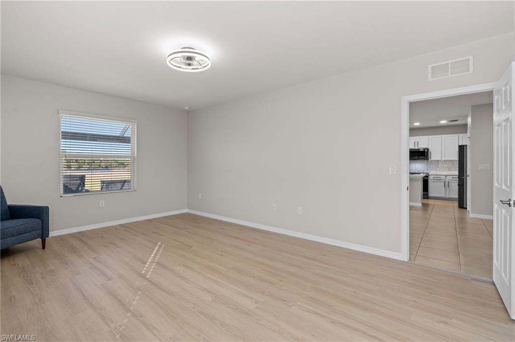 8149 Gopher Tortoise Trail Lehigh Acres, FL 33972 - Photo 25 of 50 wooden floor in an empty room