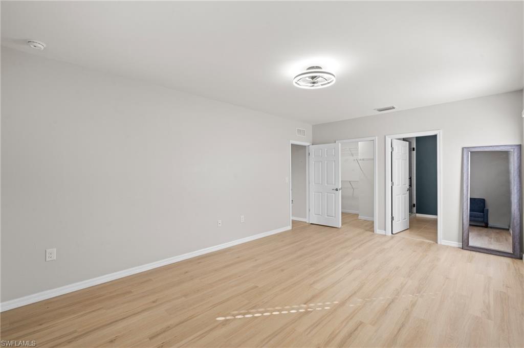 8149 Gopher Tortoise Trail Lehigh Acres, FL 33972 - Photo 26 of 50 a view of an empty room with wooden floor