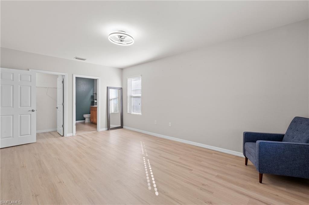 8149 Gopher Tortoise Trail Lehigh Acres, FL 33972 - Photo 27 of 50 a view of an empty room with furniture and wooden floor