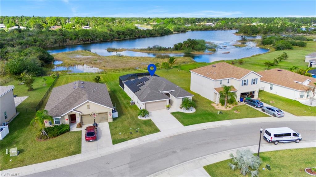 8149 Gopher Tortoise Trail Lehigh Acres, FL 33972 - Photo 3 of 50 an aerial view of a house with garden space and lake view