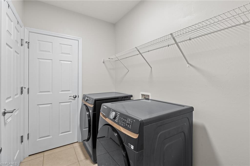 8149 Gopher Tortoise Trail Lehigh Acres, FL 33972 - Photo 38 of 50 a utility room with dryer and washer