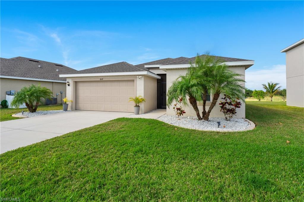 8149 Gopher Tortoise Trail Lehigh Acres, FL 33972 - Photo 4 of 50 a view of a house with a backyard