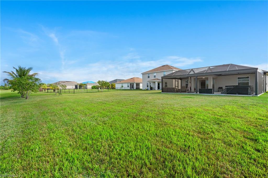 8149 Gopher Tortoise Trail Lehigh Acres, FL 33972 - Photo 41 of 50 a view of a house with a big yard