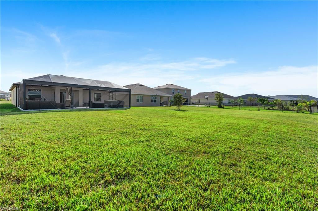 8149 Gopher Tortoise Trail Lehigh Acres, FL 33972 - Photo 42 of 50 a view of a house with a big yard