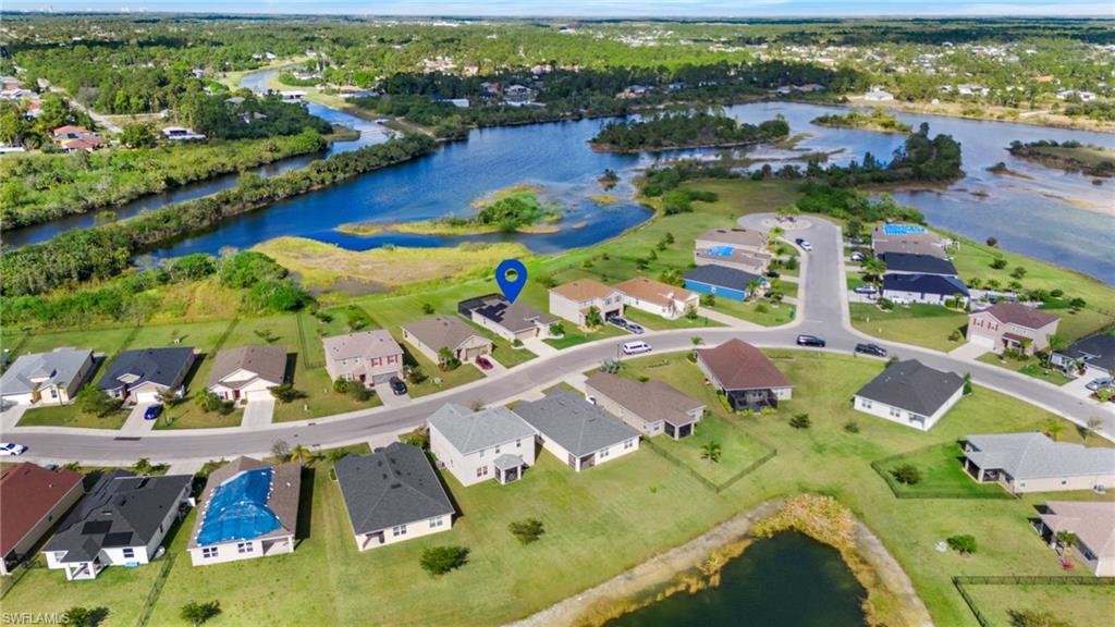 8149 Gopher Tortoise Trail Lehigh Acres, FL 33972 - Photo 49 of 50 an aerial view of residential houses with outdoor space