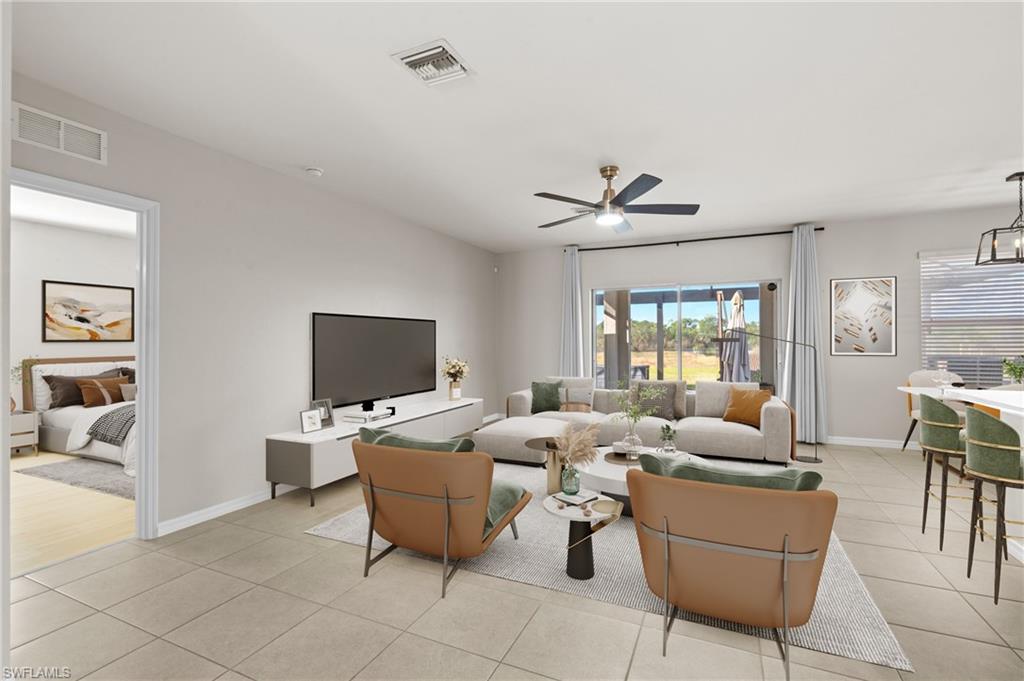 8149 Gopher Tortoise Trail Lehigh Acres, FL 33972 - Photo 10 of 50 a living room with furniture and a flat screen tv