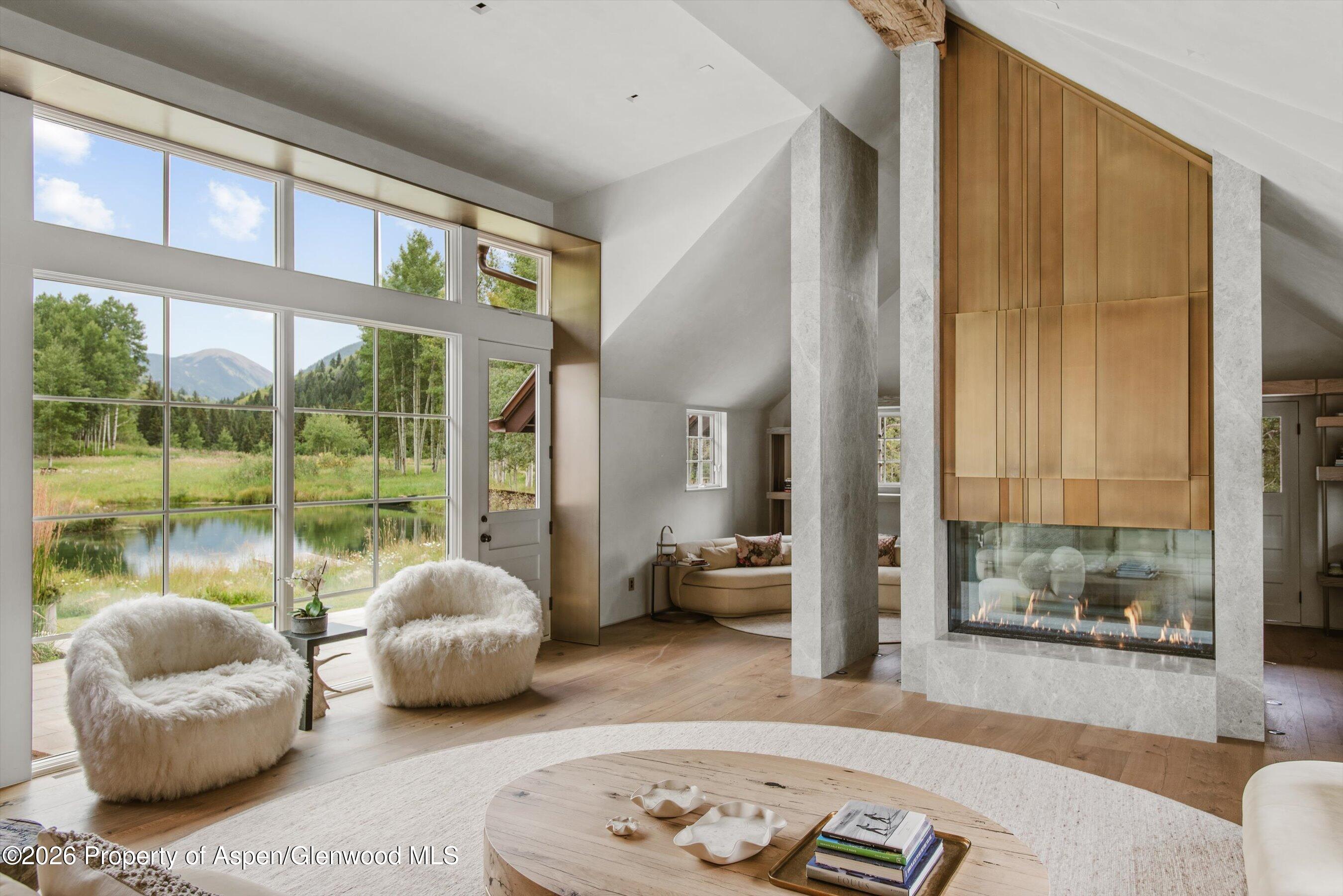 5387 Castle Creek Road Aspen, CO 81612 - Photo 6 of 25 a bedroom with furniture and large windows