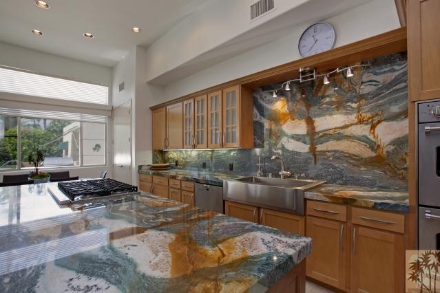 37232 Palm View Road Rancho Mirage, CA 92270 - Photo 15 of 25 a kitchen with counter top space stove sink and living room
