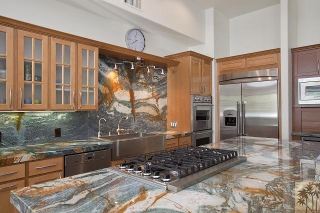 37232 Palm View Road Rancho Mirage, CA 92270 - Photo 16 of 25 a kitchen with stainless steel appliances granite countertop a stove a sink and a refrigerator