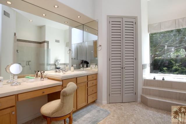 37232 Palm View Road Rancho Mirage, CA 92270 - Photo 18 of 25 a bathroom with a double vanity sink a mirror and a bathtub