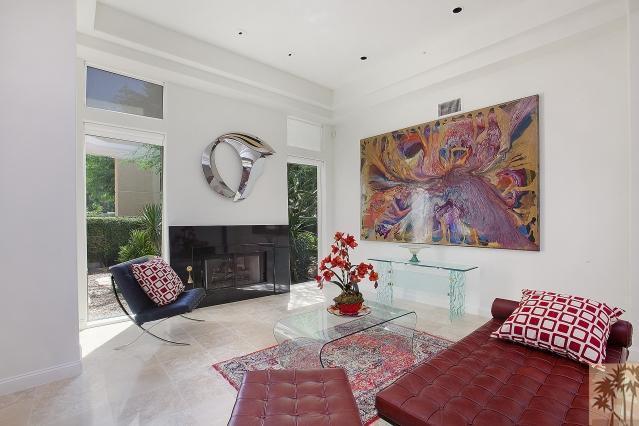37232 Palm View Road Rancho Mirage, CA 92270 - Photo 7 of 25 a living room with furniture flowers and a fireplace