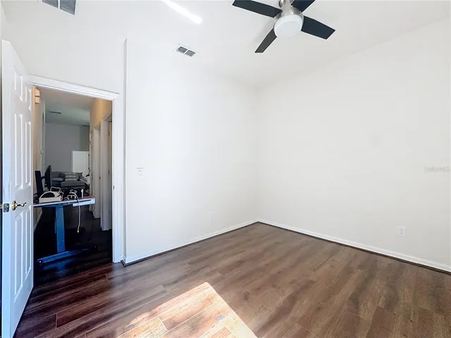 a bedroom with a bed and a mirror on dresser