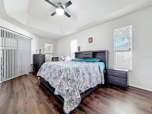 a bathroom with a granite countertop toilet sink and mirror