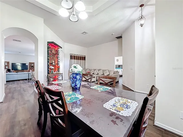 a view of a dining room with furniture window and wooden floor