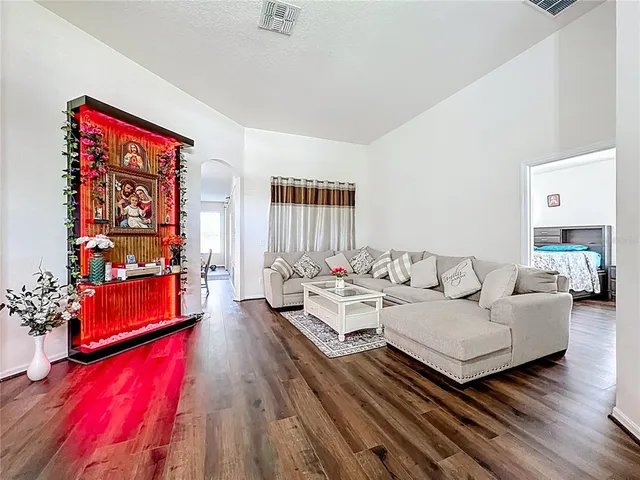a living room with furniture and wooden floor