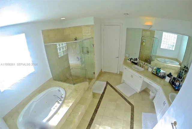 a bathroom with a sink mirror vanity and toilet