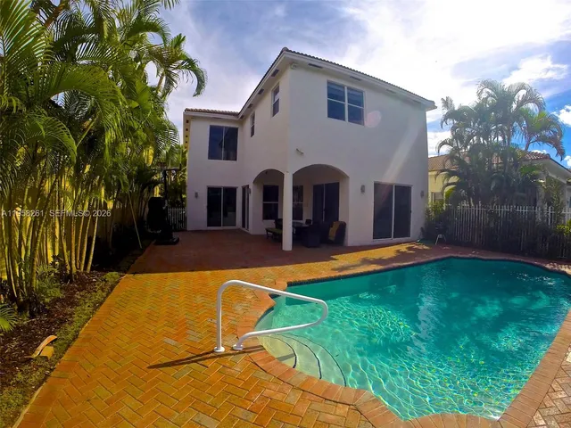 a view of house with swimming pool yard and outdoor seating