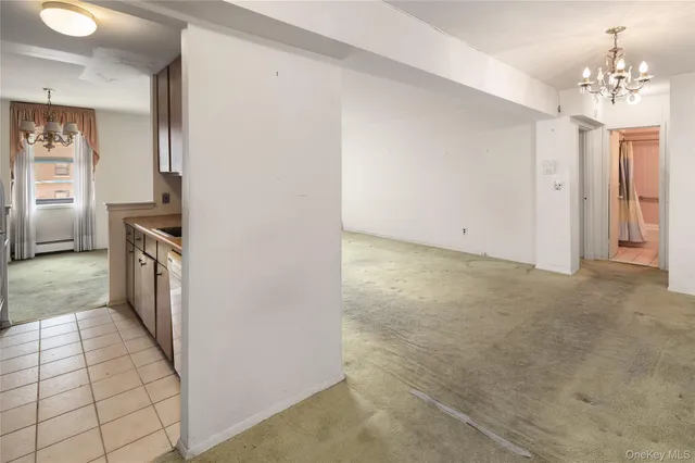 a kitchen with granite countertop a refrigerator and a stove top oven