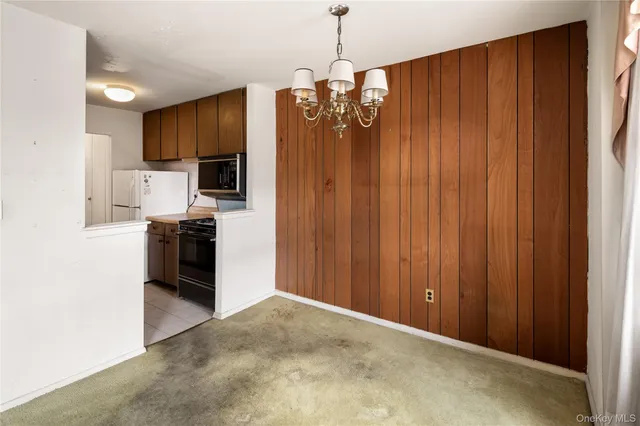 a view of kitchen with refrigerator and microwave