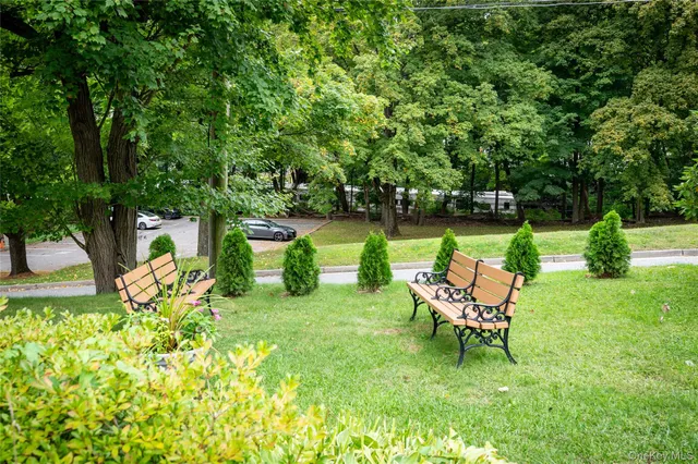a view of a chair and table in the garden