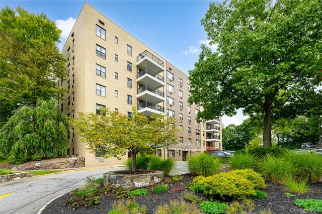 a view of a tall building next to a road