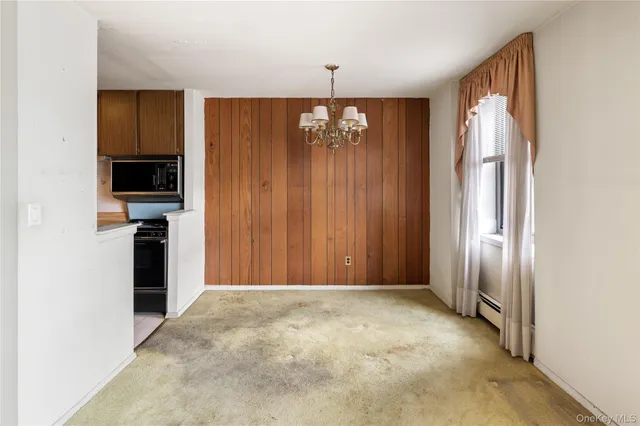 a view of a kitchen with a refrigerator and a stove top oven