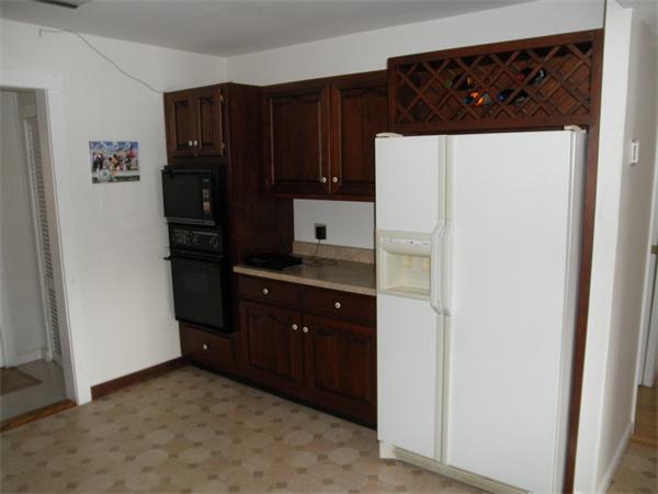 26 Old Acres Road Holland, MA 01521 - Photo 3 of 15 a kitchen with a refrigerator and cabinets