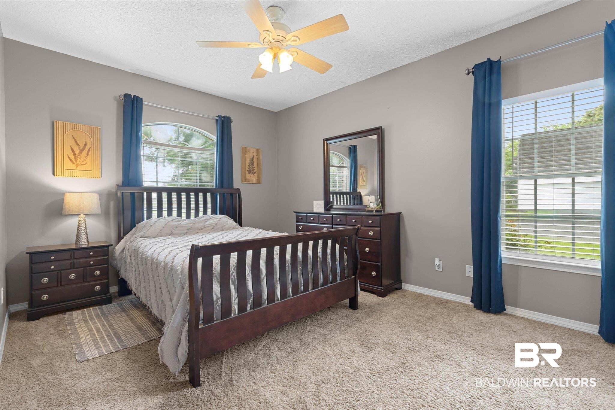 3170 Scott Dairy Loop Road West Mobile, AL 36695 - Photo 10 of 24 Carpeted room featuring a ceiling fan, two windows with blinds, and neutral wall tones