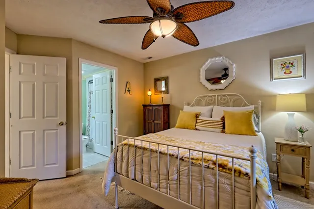 a view of a room that has a large window and wooden floor