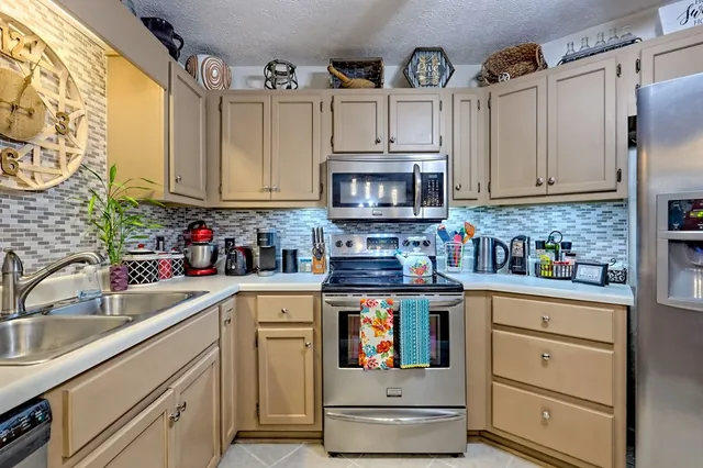 a view of a dining room with furniture a rug and wooden floor