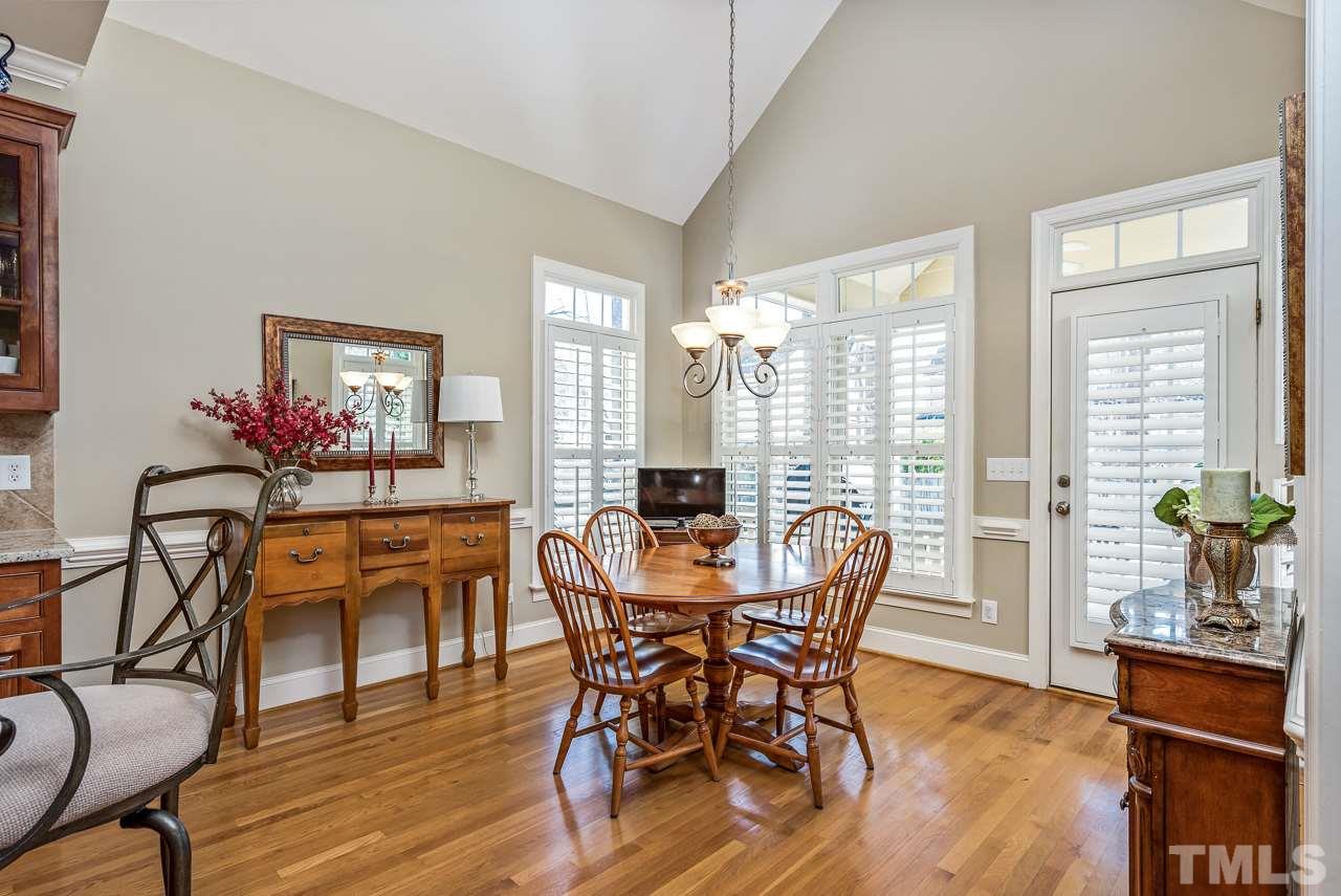 7913 Pine Timber Drive Raleigh, NC 27613 - Photo 12 of 25 a view of a dining room with furniture window and wooden floor