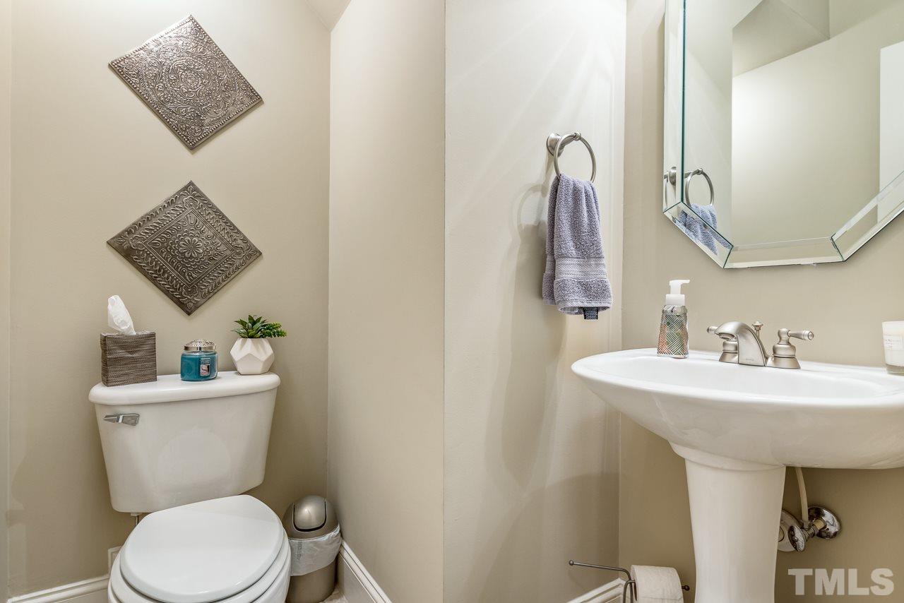 7913 Pine Timber Drive Raleigh, NC 27613 - Photo 13 of 25 a bathroom with a toilet sink and mirror