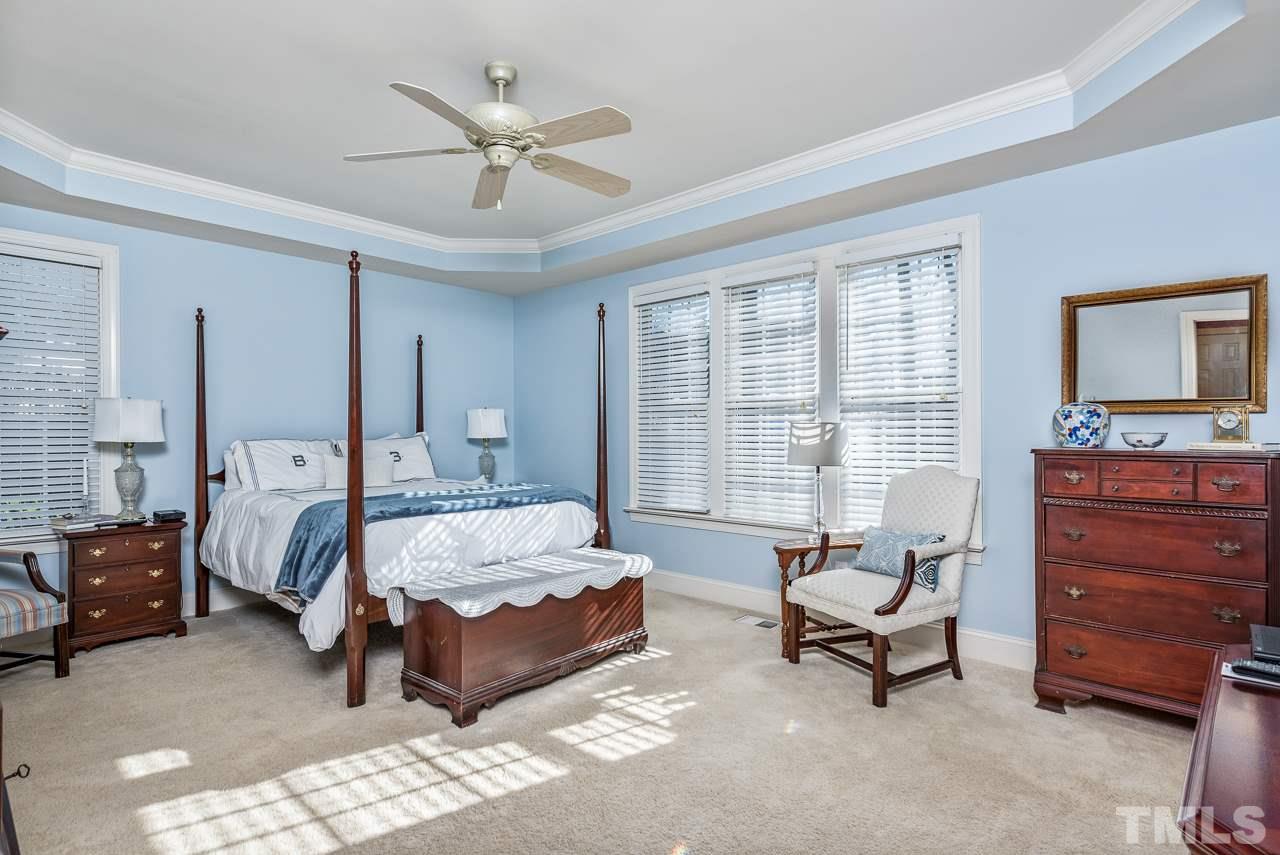 7913 Pine Timber Drive Raleigh, NC 27613 - Photo 14 of 25 a spacious bedroom with a bed and a couch