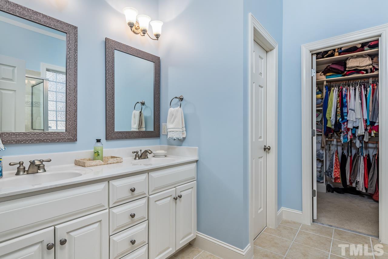 7913 Pine Timber Drive Raleigh, NC 27613 - Photo 16 of 25 a en suite bathroom with a double vanity sink and a mirror