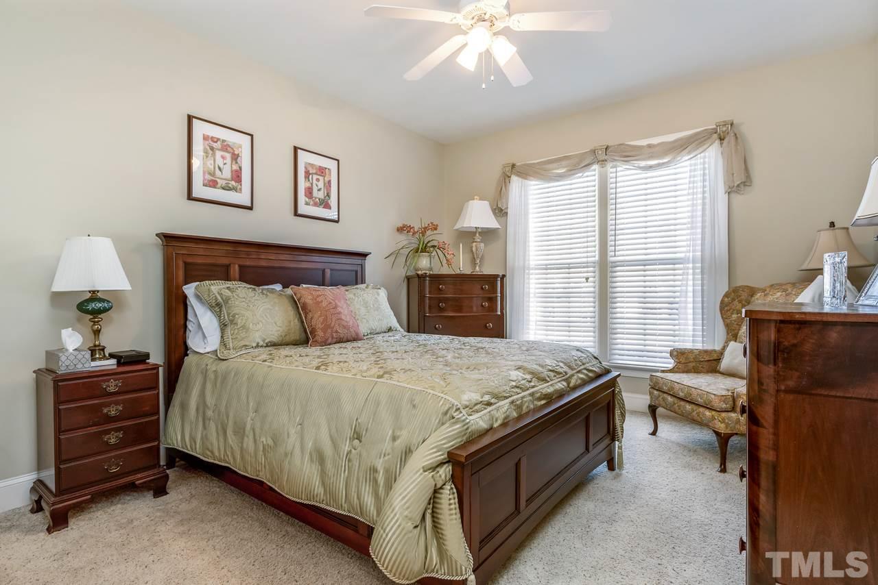 7913 Pine Timber Drive Raleigh, NC 27613 - Photo 18 of 25 a bed sitting in a bedroom and table
