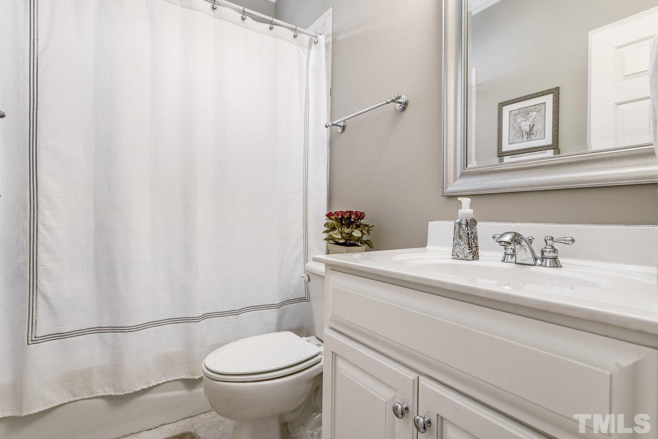 7913 Pine Timber Drive Raleigh, NC 27613 - Photo 19 of 25 a bathroom with a granite countertop sink and a toilet