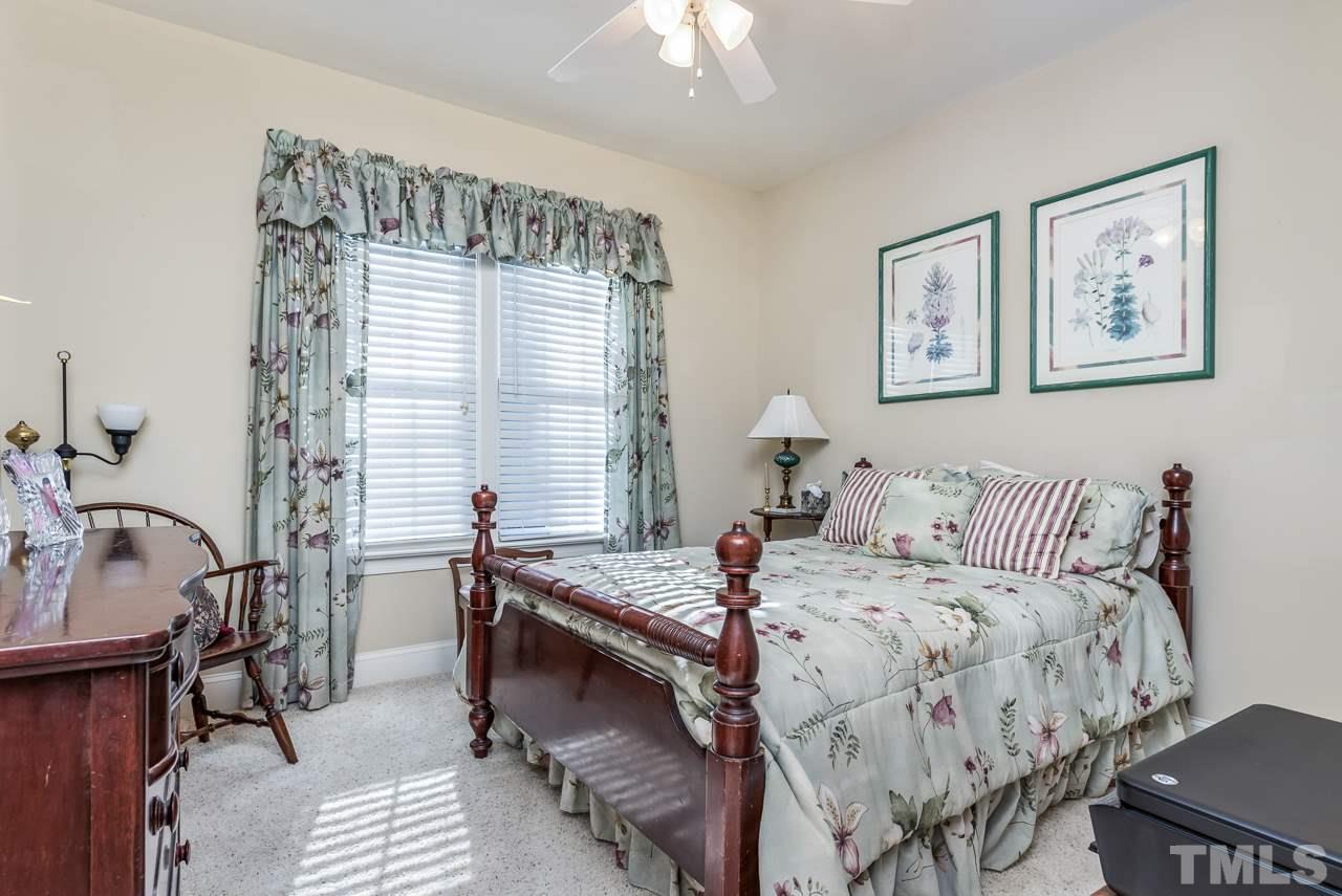 7913 Pine Timber Drive Raleigh, NC 27613 - Photo 20 of 25 a bedroom with a bed and a table chair