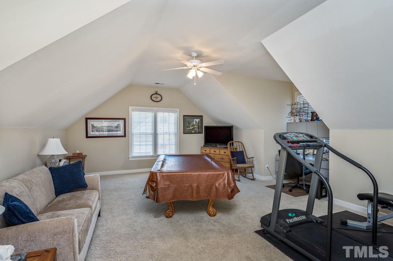 7913 Pine Timber Drive Raleigh, NC 27613 - Photo 21 of 25 a living room with furniture and a flat screen tv