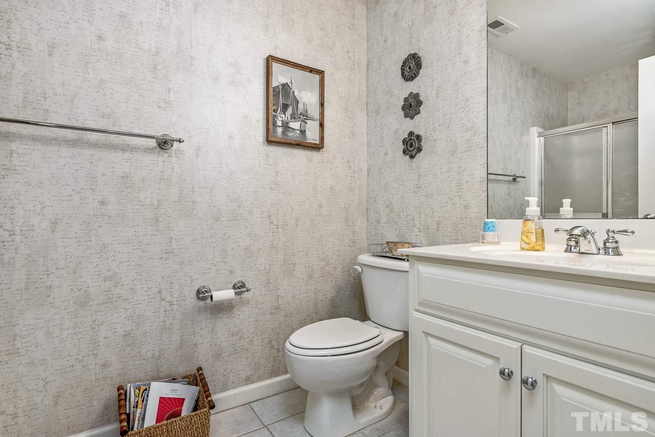 7913 Pine Timber Drive Raleigh, NC 27613 - Photo 22 of 25 a bathroom with a toilet a sink and a shower