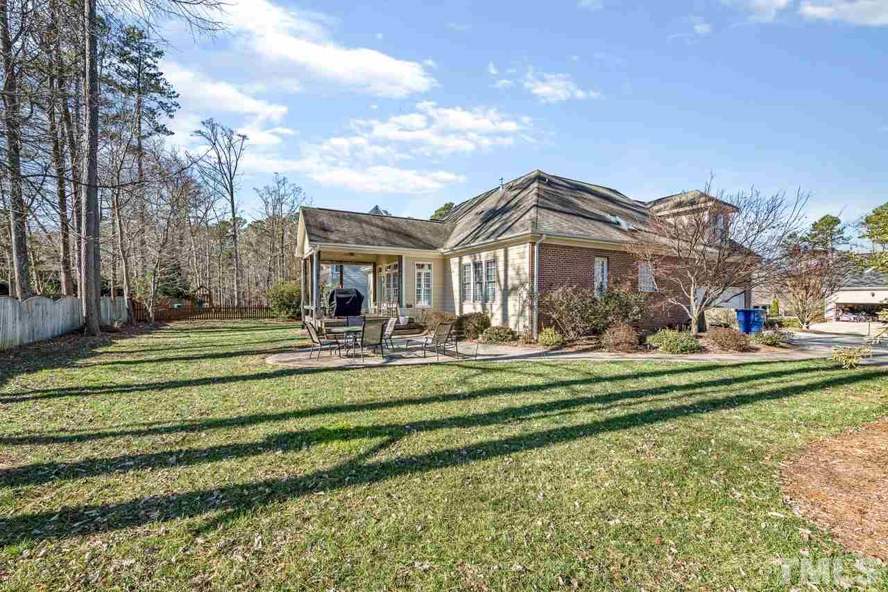 7913 Pine Timber Drive Raleigh, NC 27613 - Photo 23 of 25 a front view of a house with a yard table and chairs