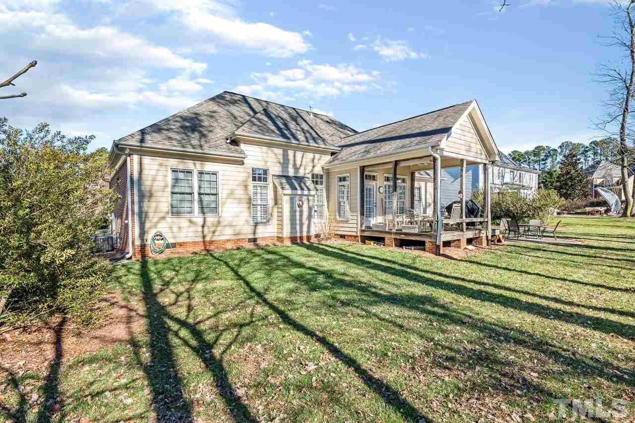 7913 Pine Timber Drive Raleigh, NC 27613 - Photo 25 of 25 a front view of a house with a yard table and chairs