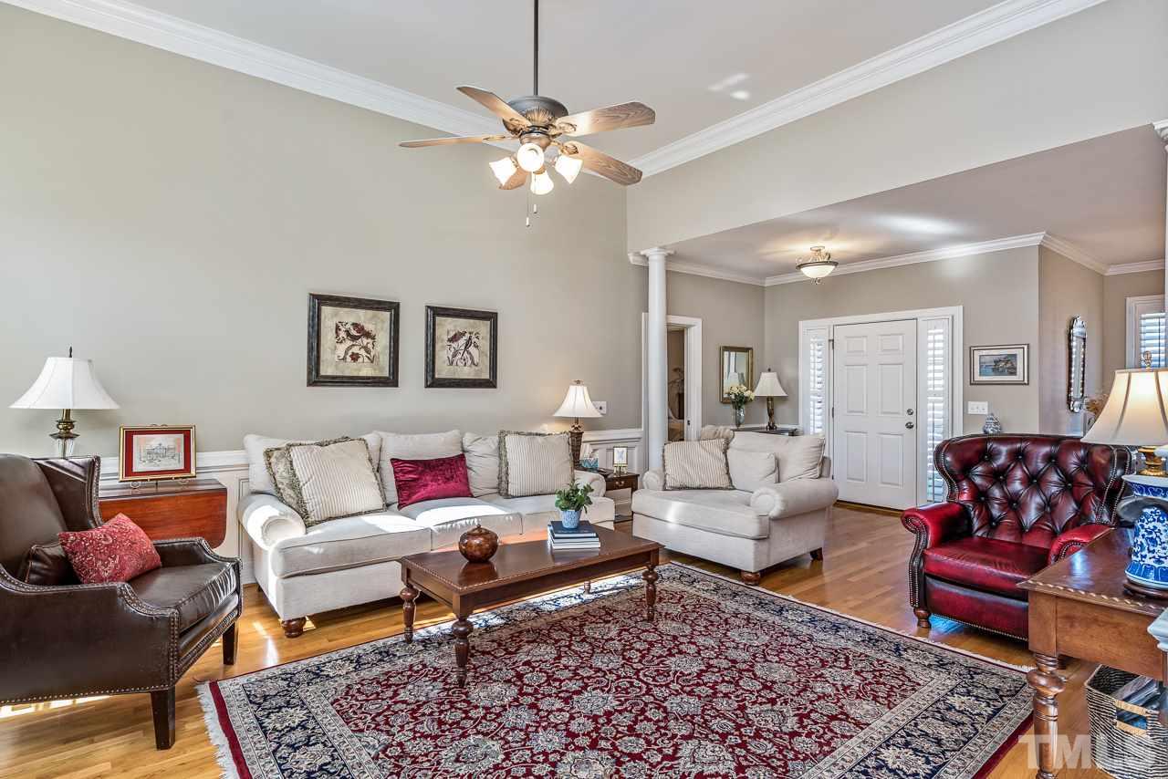 7913 Pine Timber Drive Raleigh, NC 27613 - Photo 5 of 25 a living room with furniture and a chandelier