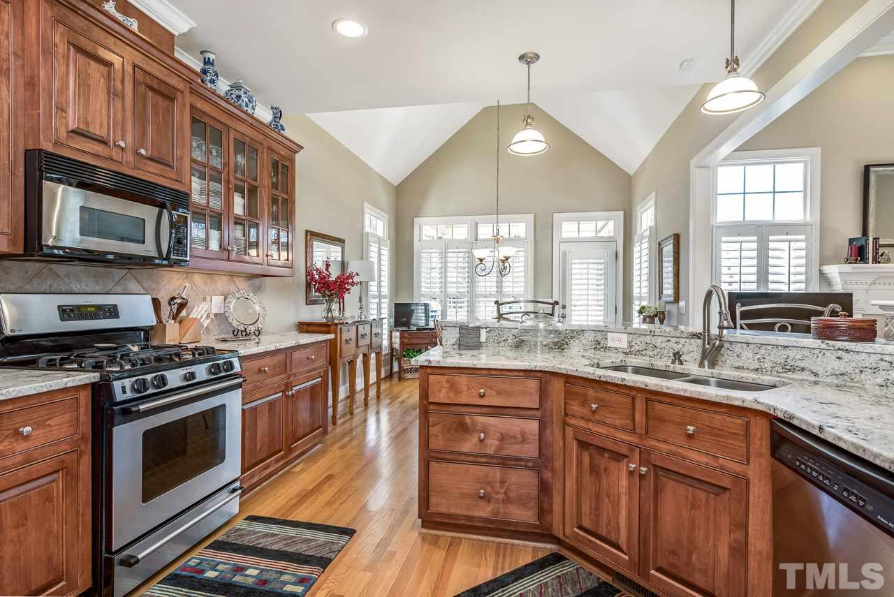 7913 Pine Timber Drive Raleigh, NC 27613 - Photo 8 of 25 a kitchen with stainless steel appliances granite countertop a stove a sink and a microwave