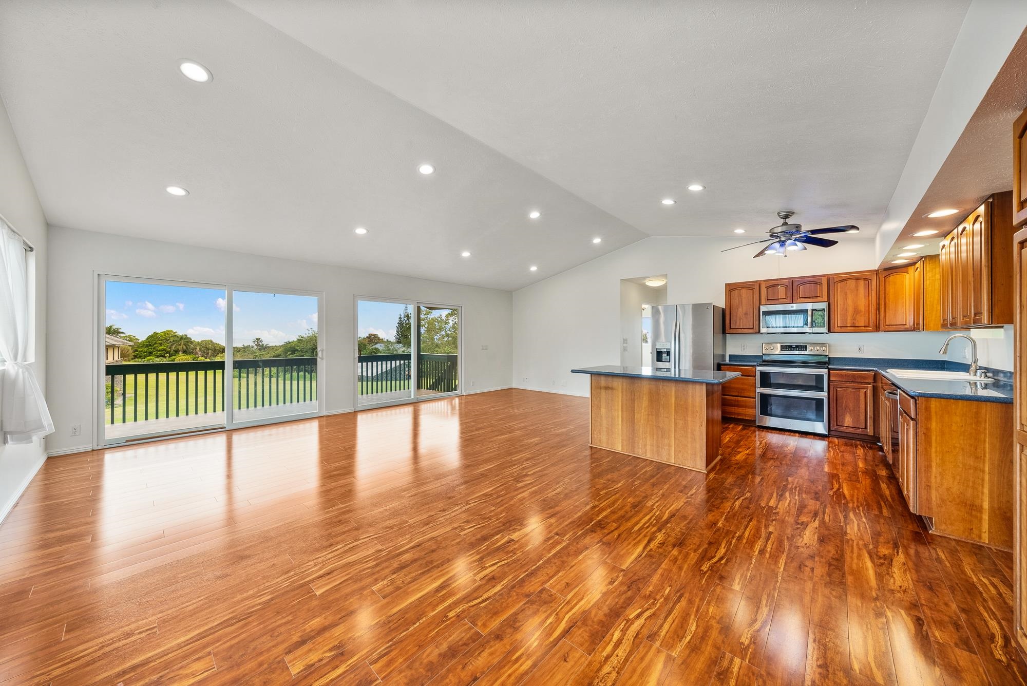 4535 Opana Place Haiku, HI 96708 - Photo 5 of 43 a view of a living room and kitchen floor to ceiling window and wooden floor